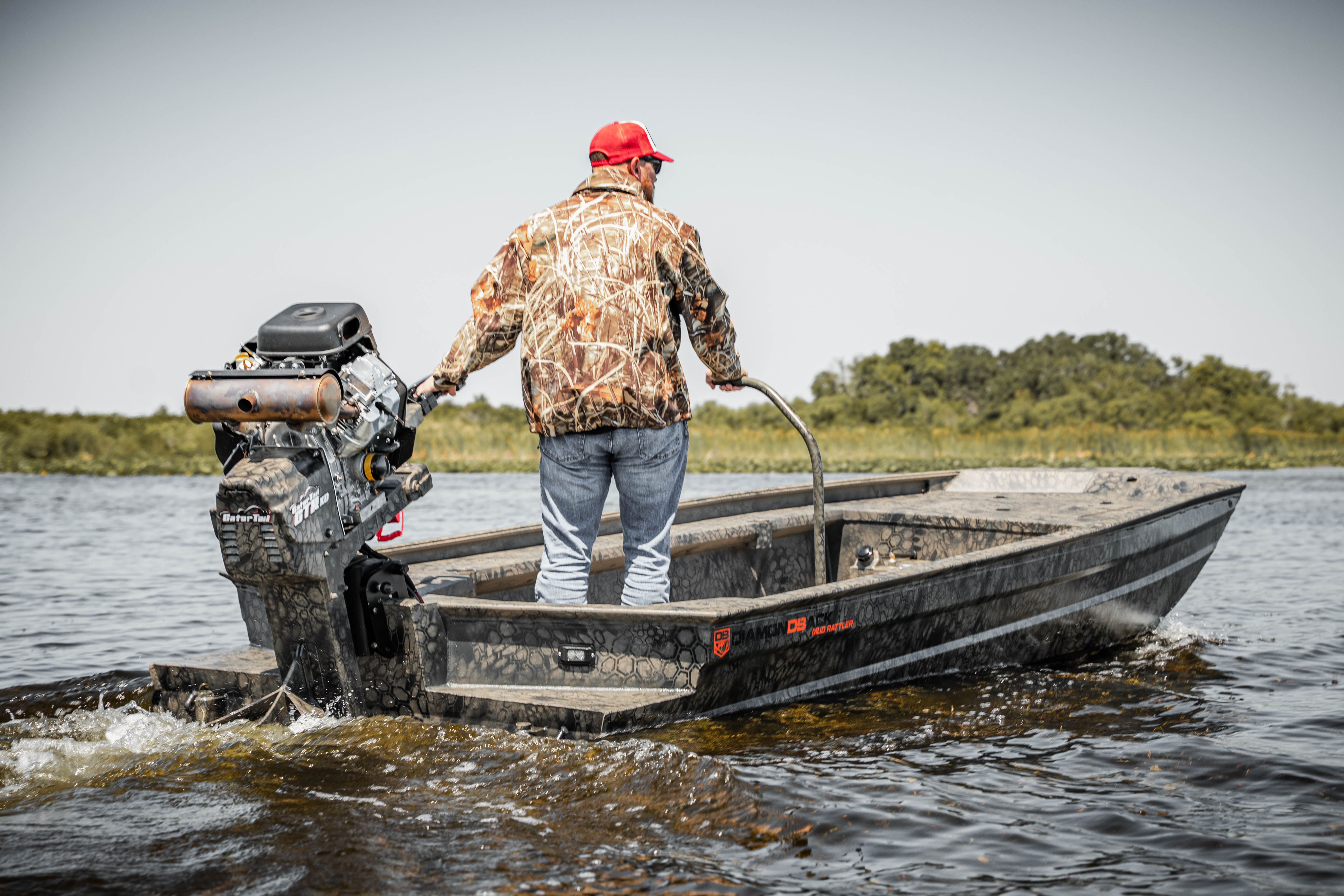 Hunter standing in a Diamondback boat in the marsh at dawn